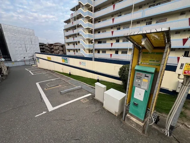 敷地側から見たコインパーキング。区画線の引かれた駐車スペースと精算機があります。